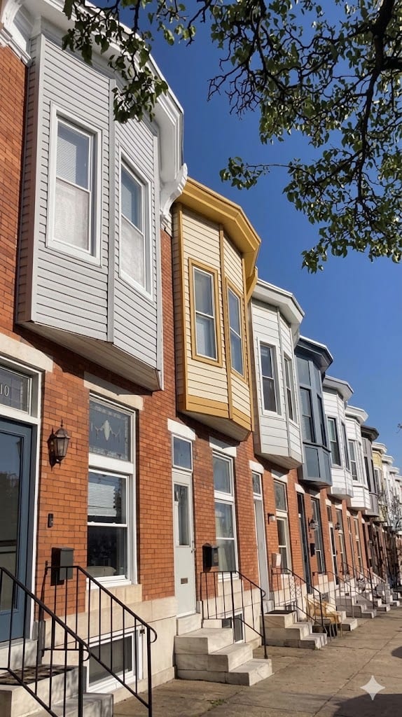 A block of classic rowhomes with bay windows and marble steps in Canton, Baltimore, the kind of homes Deep Roots REI buys as-is for cash.