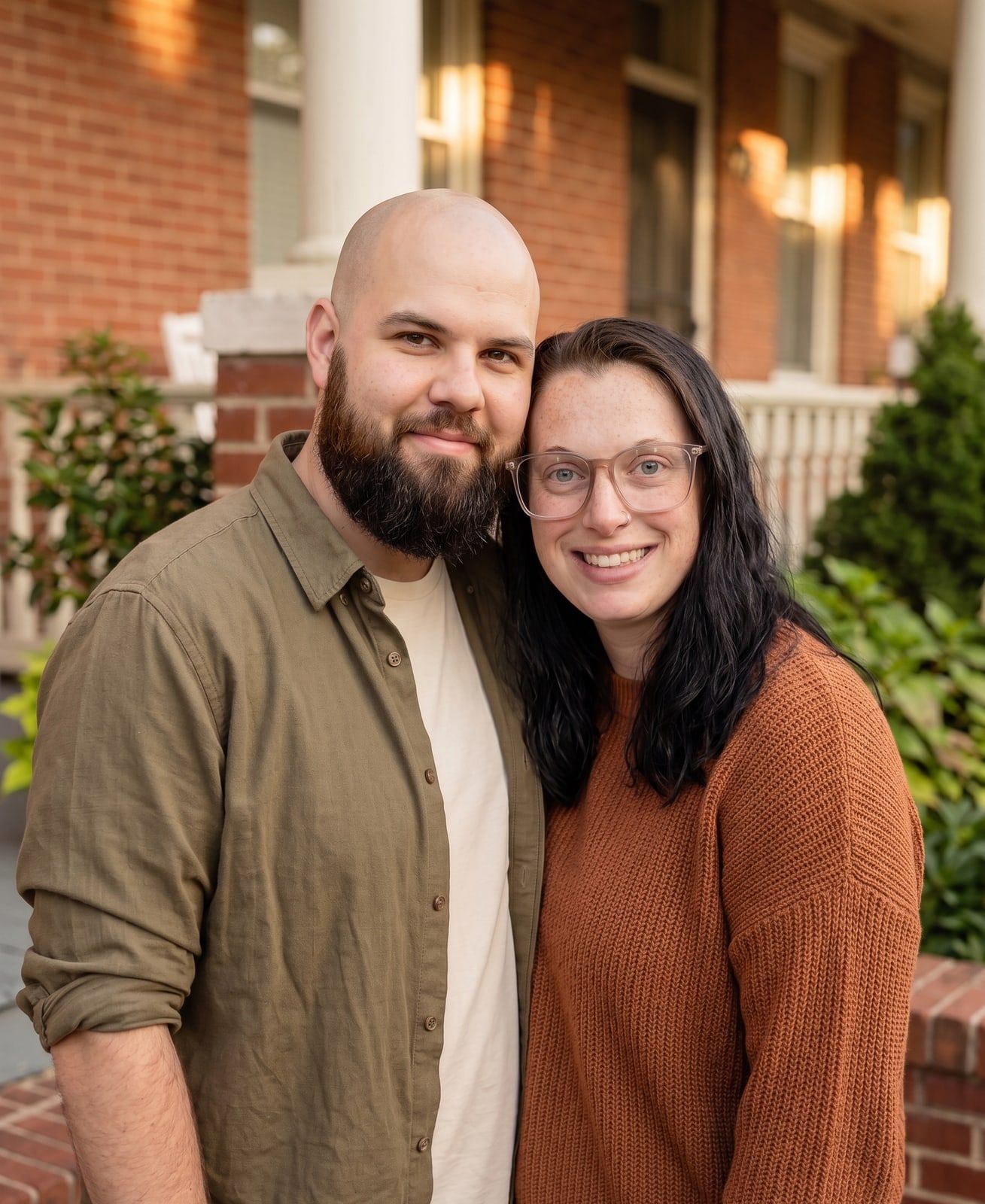 Matthew and Marisa Larkin, the local family behind Deep Roots REI, on a Baltimore front step.